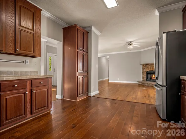 a kitchen with stainless steel appliances granite countertop a refrigerator and a stove top oven