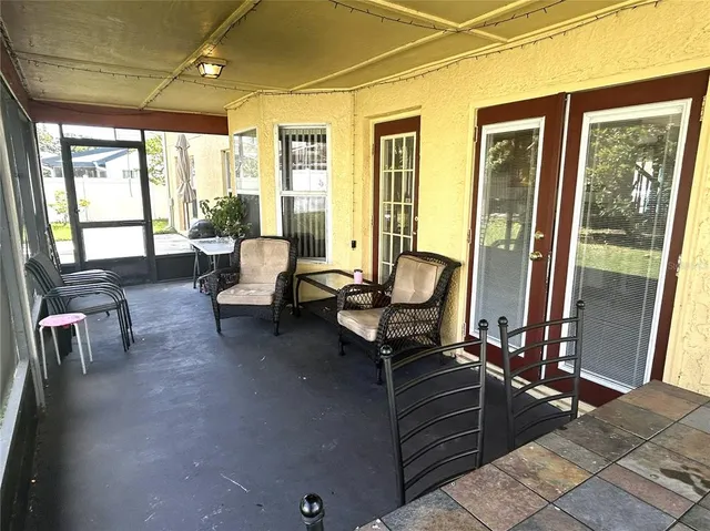 a living room with furniture and a floor to ceiling window