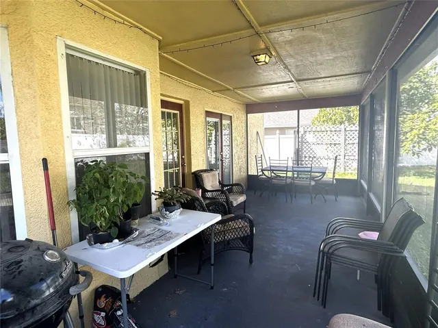 a living room with furniture and a floor to ceiling window