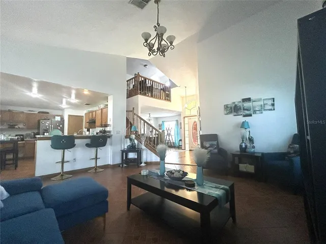 a living room with furniture and a chandelier
