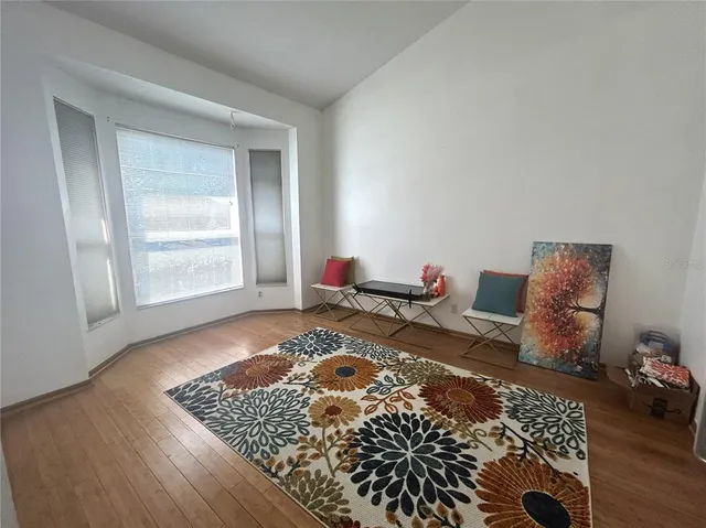 a bed sitting in a room next to a window