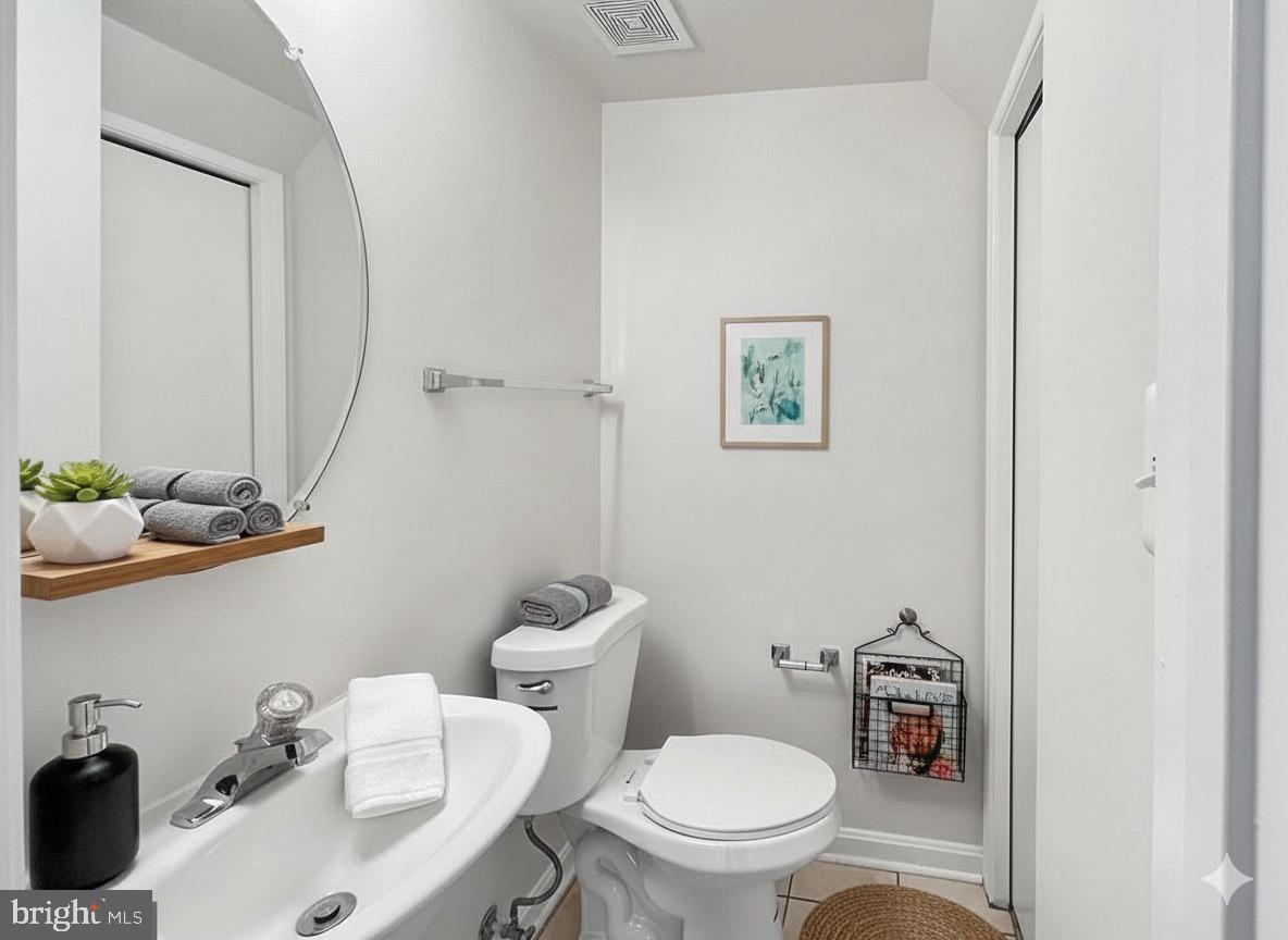 102 Crossbill Way Frederick, MD 21702 - Photo 12 of 16 a bathroom with a toilet a sink and mirror