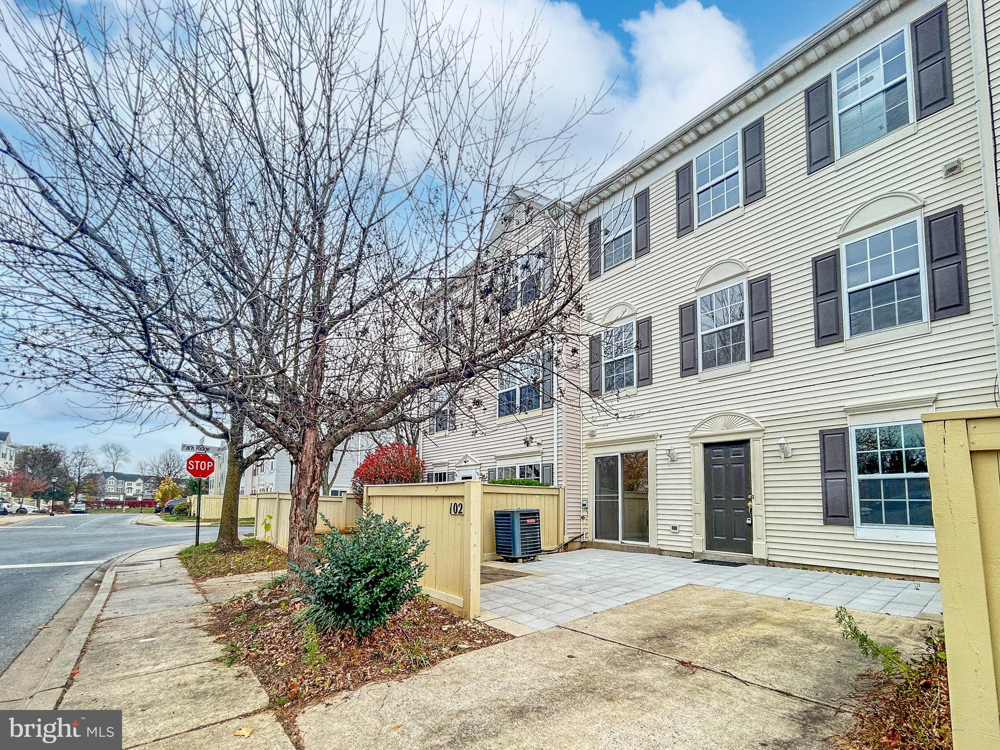102 Crossbill Way Frederick, MD 21702 - Photo 16 of 16 a front view of a building with large trees