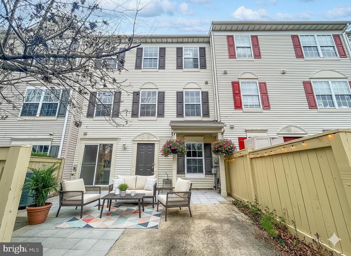 102 Crossbill Way Frederick, MD 21702 - Photo 2 of 16 a view of a patio with table and chairs and potted plants