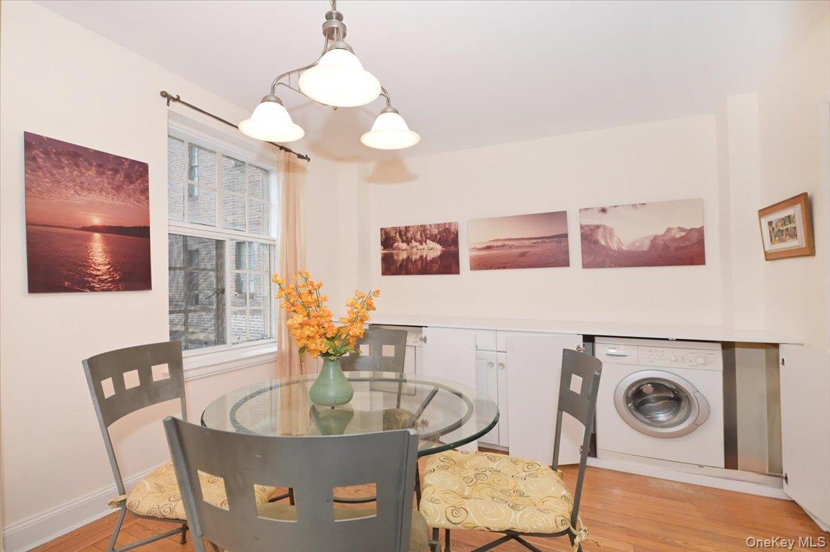 160 Middle Neck Road, Unit 2G Great Neck, NY 11021 - Photo 9 of 41 a dining room with furniture and chandelier