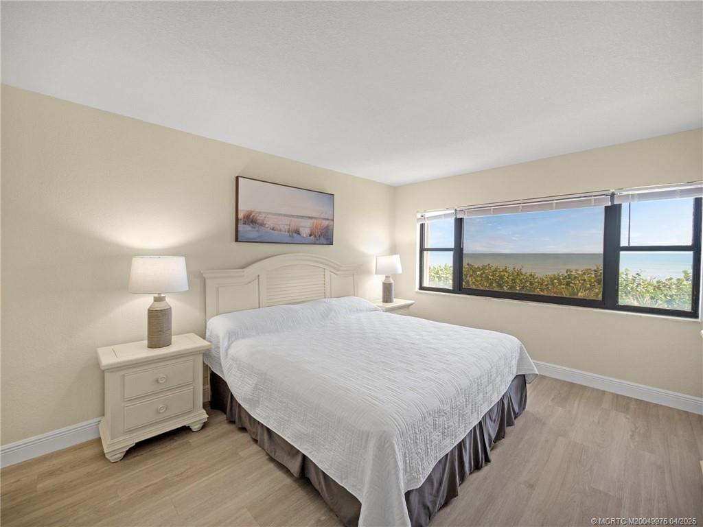 7380 South Ocean Drive, Unit 220 Jensen Beach, FL 34957 - Photo 13 of 33 a spacious bedroom with a bed and window