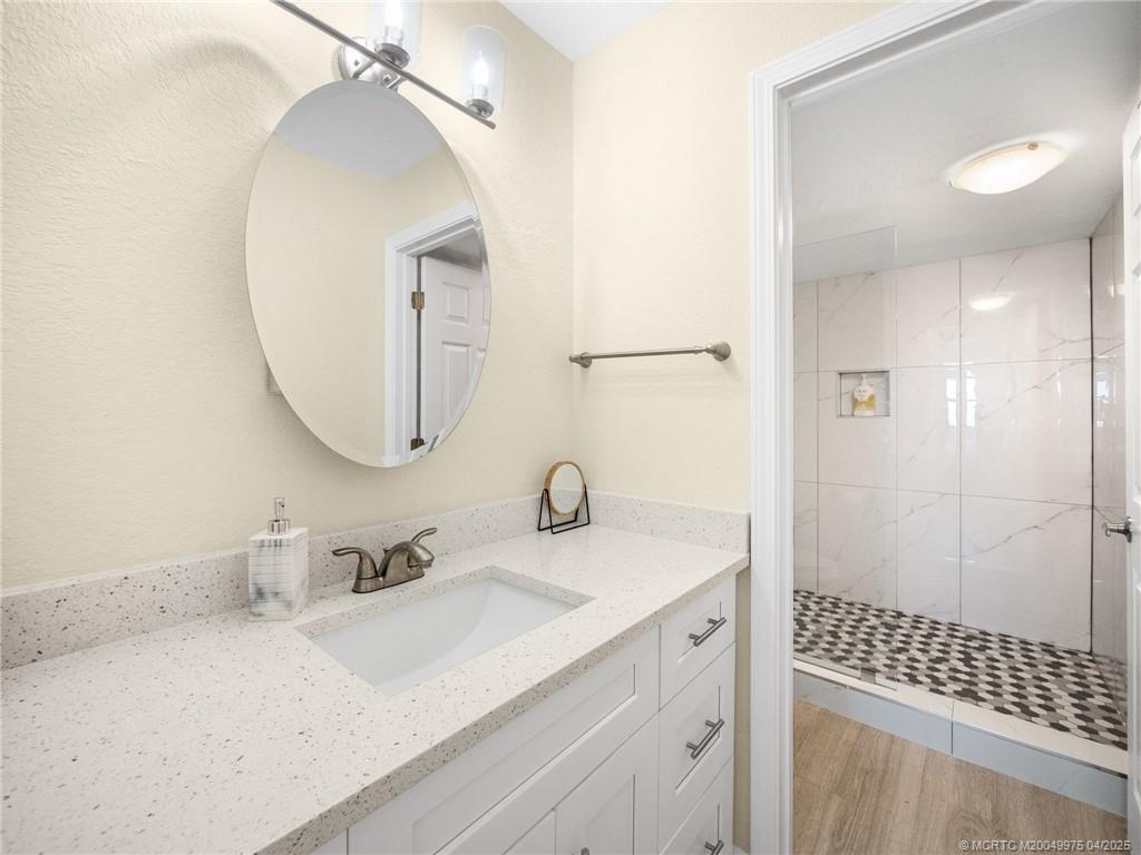 7380 South Ocean Drive, Unit 220 Jensen Beach, FL 34957 - Photo 15 of 33 a bathroom with a sink and a mirror
