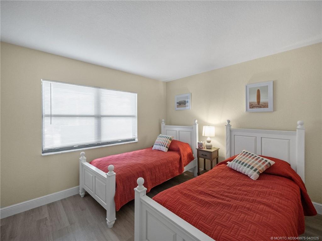 7380 South Ocean Drive, Unit 220 Jensen Beach, FL 34957 - Photo 17 of 33 a bedroom with two beds and a window