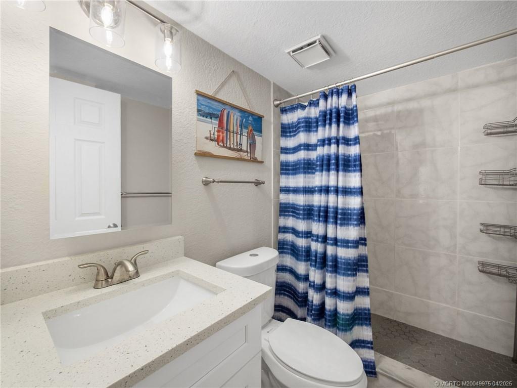 7380 South Ocean Drive, Unit 220 Jensen Beach, FL 34957 - Photo 18 of 33 a bathroom with a sink toilet and shower