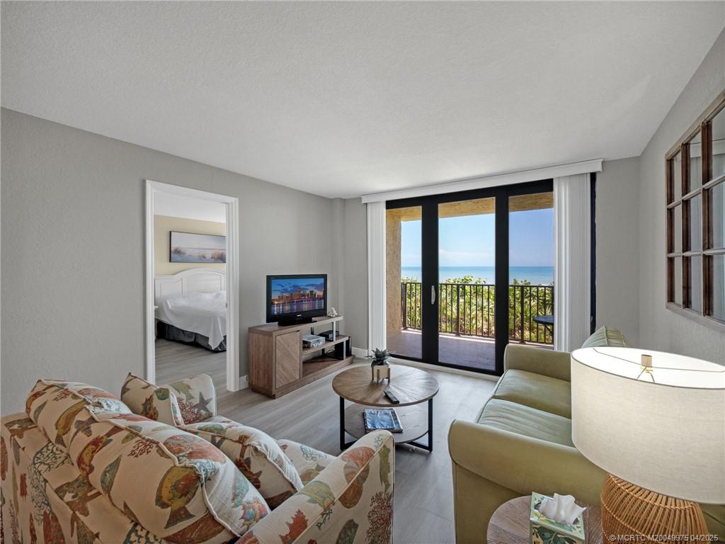 7380 South Ocean Drive, Unit 220 Jensen Beach, FL 34957 - Photo 10 of 33 a bedroom with a bed and large windows