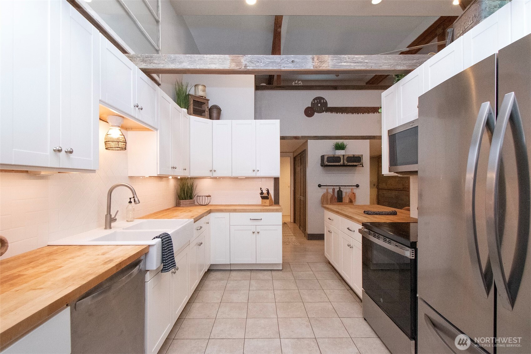 1515 Olson Road Sequim, WA 98382 - Photo 12 of 40 a kitchen with stainless steel appliances granite countertop a sink a stove and a refrigerator