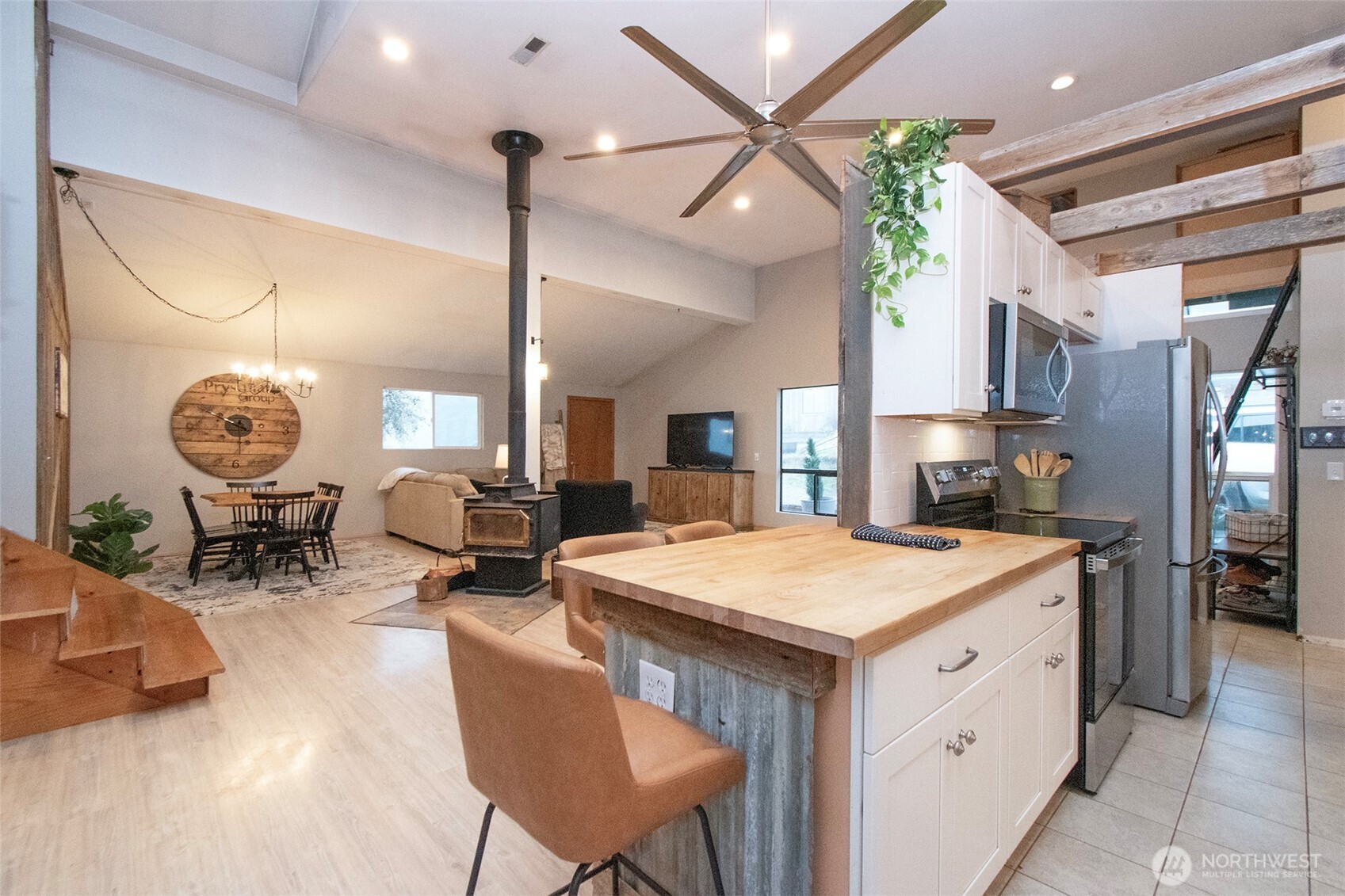 1515 Olson Road Sequim, WA 98382 - Photo 16 of 40 a kitchen that has a table chairs a stove and a wooden floors
