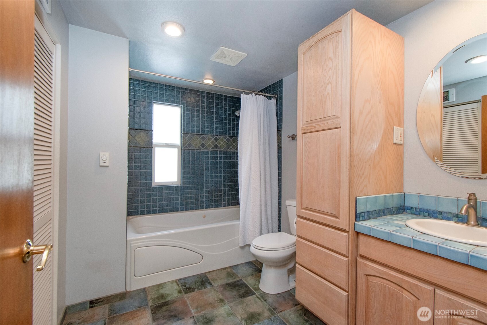 1515 Olson Road Sequim, WA 98382 - Photo 18 of 40 a bathroom with a granite countertop sink toilet and shower