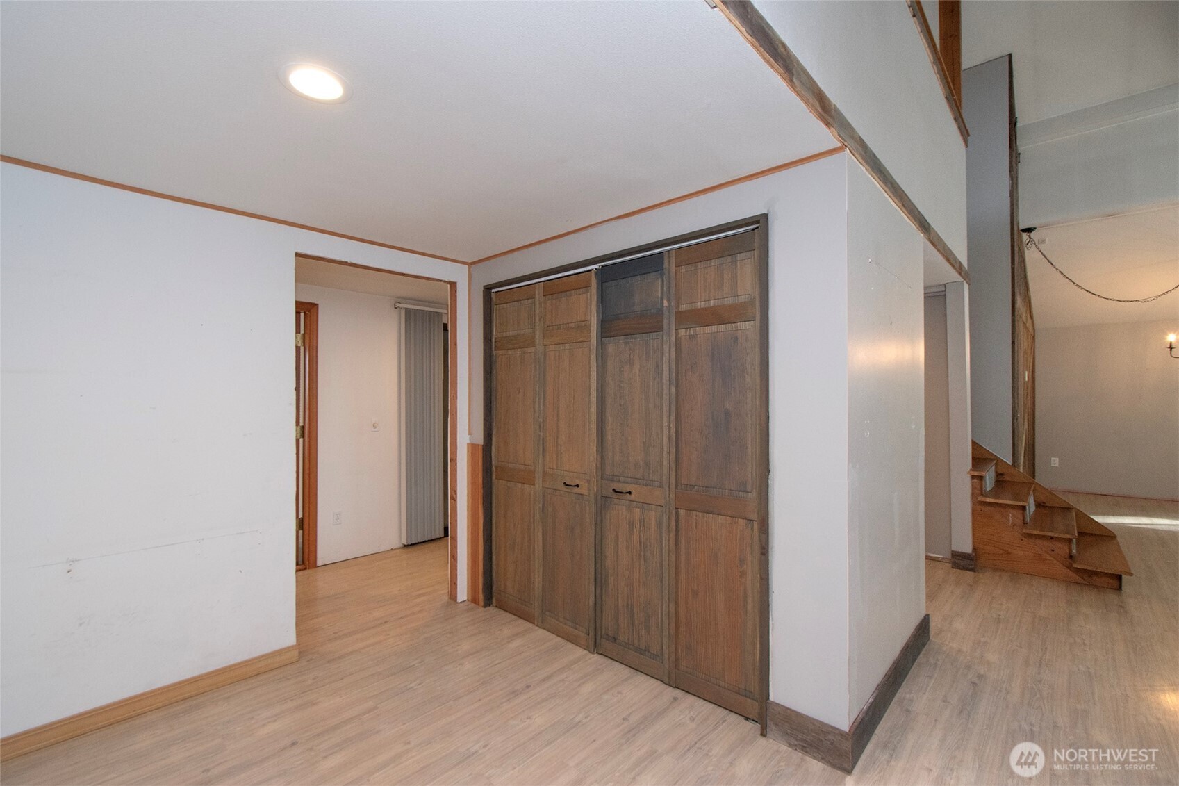 1515 Olson Road Sequim, WA 98382 - Photo 21 of 40 a view of a hallway with wooden floor and a bathroom