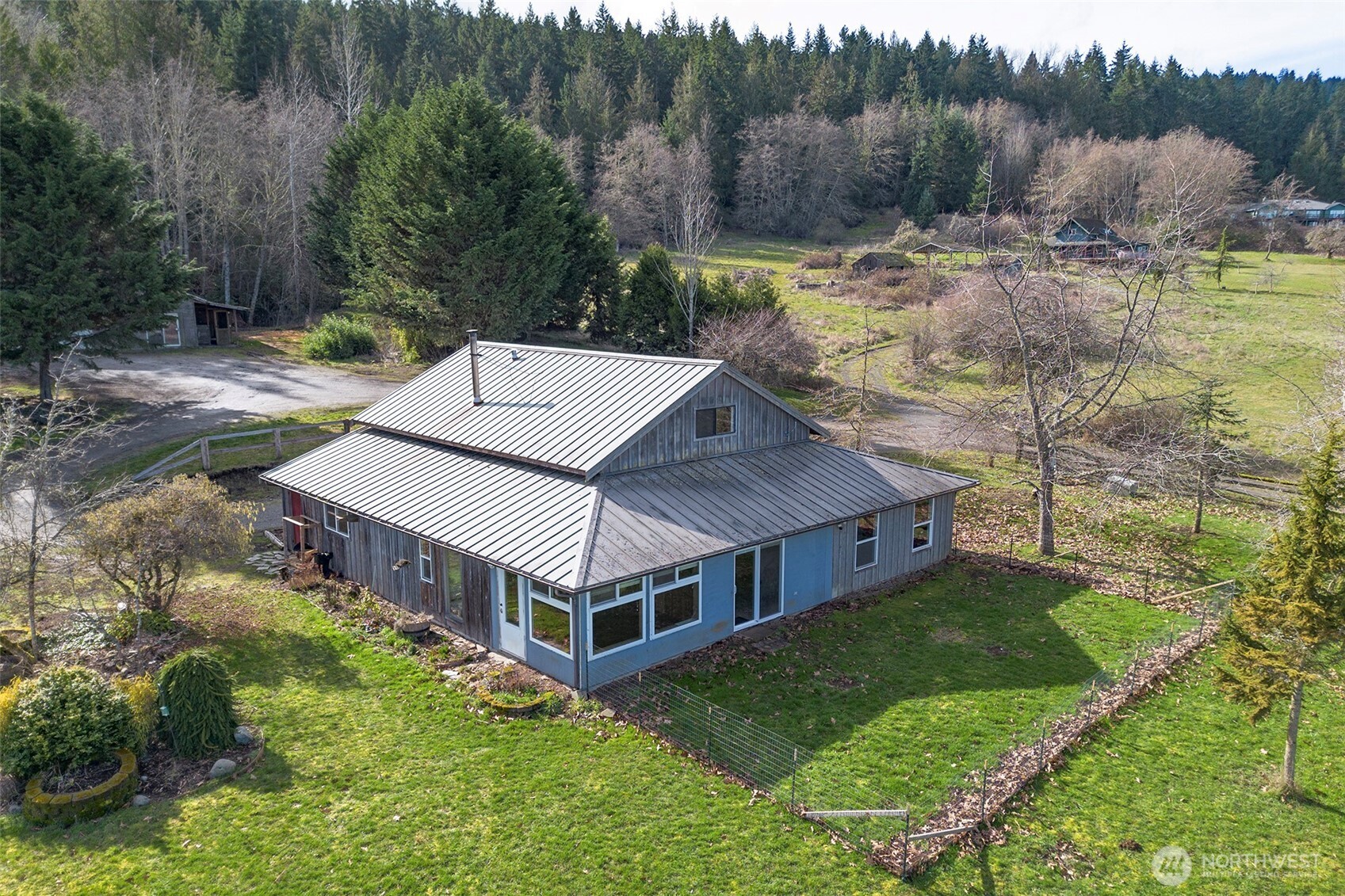 1515 Olson Road Sequim, WA 98382 - Photo 29 of 40 a view of a house with a yard and sitting area