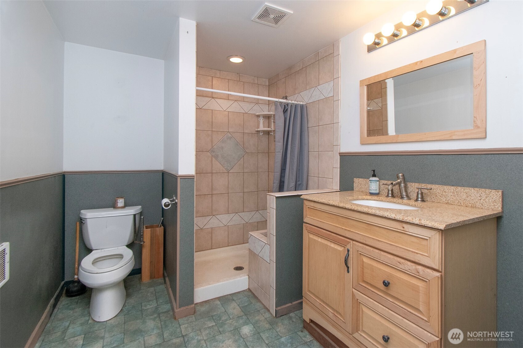 1515 Olson Road Sequim, WA 98382 - Photo 38 of 40 a spacious bathroom with a granite countertop sink toilet and shower