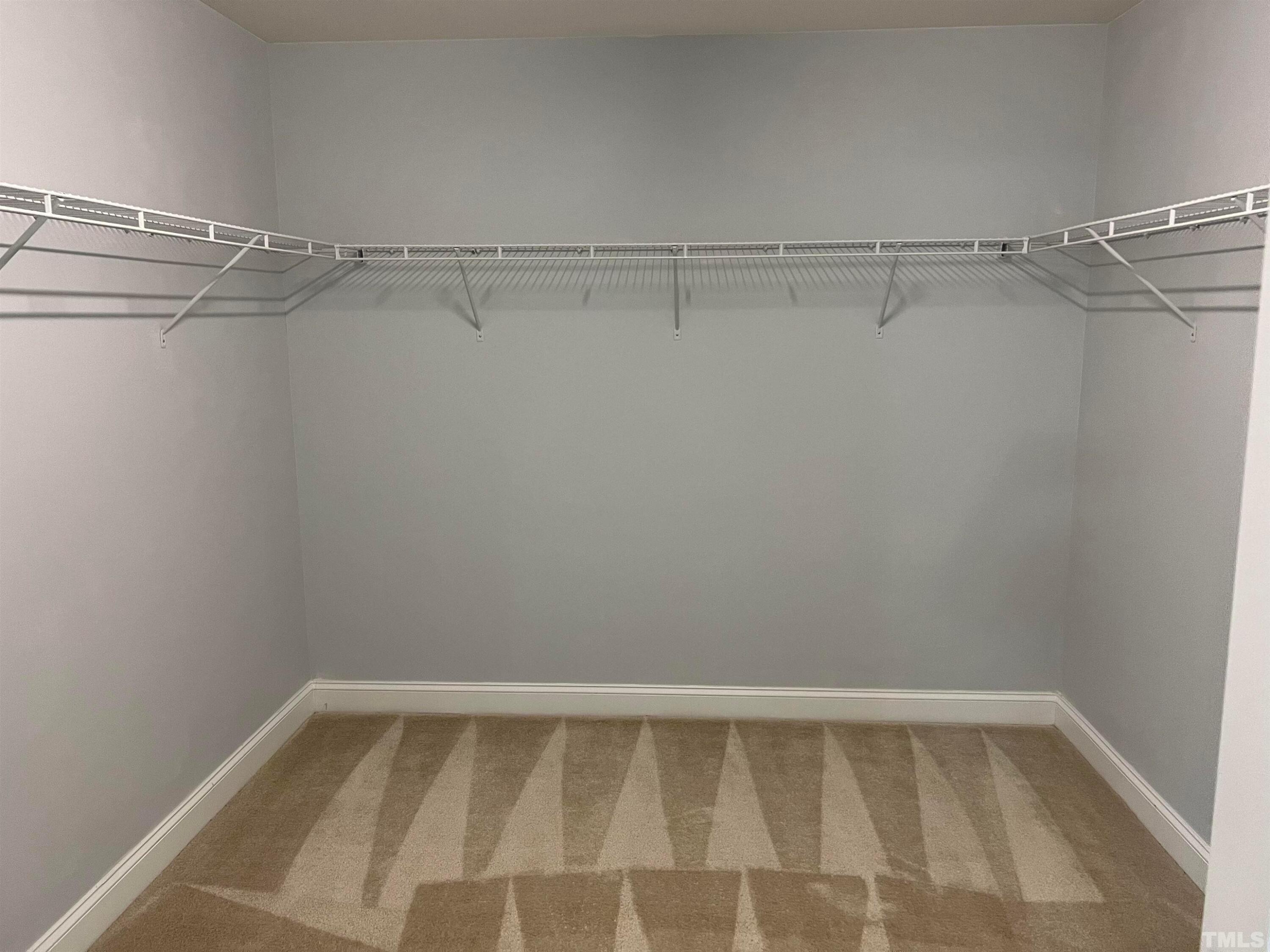 121 Red Bark Court Apex, NC 27539 - Photo 16 of 24 a view of a room with racks on the wall