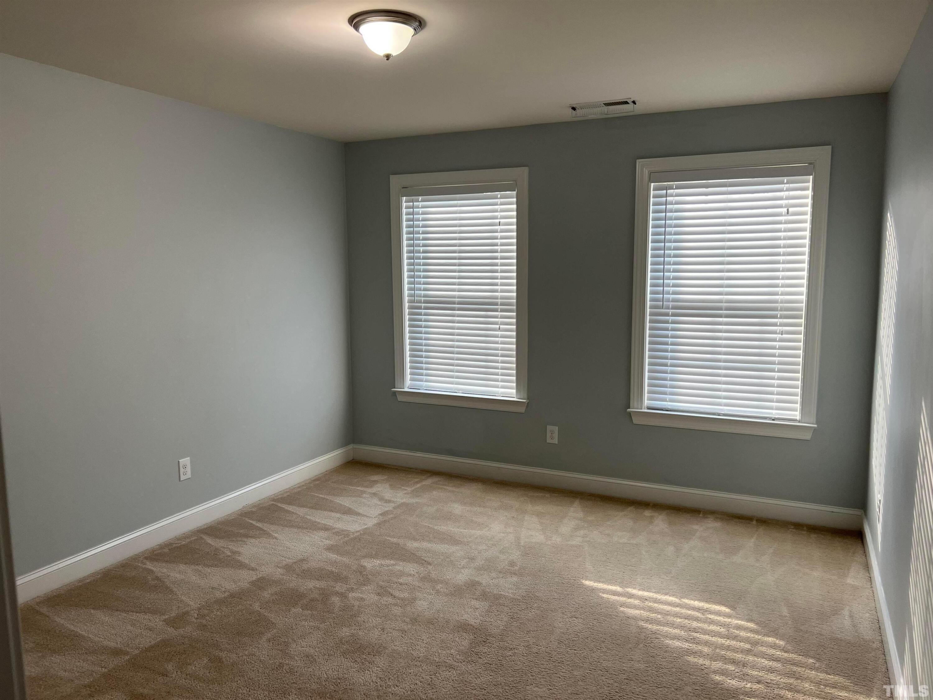 121 Red Bark Court Apex, NC 27539 - Photo 17 of 24 a view of an empty room with a window