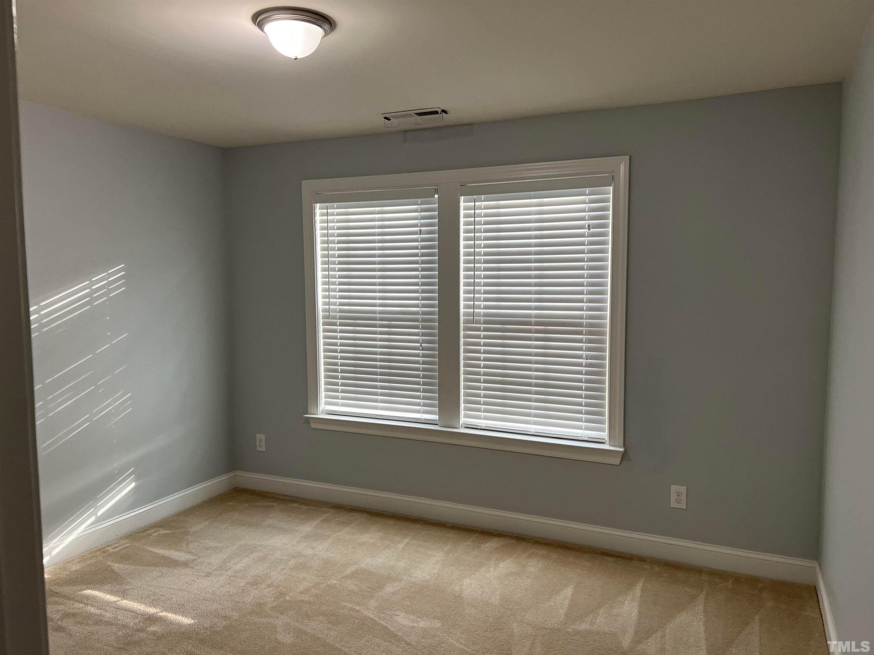 121 Red Bark Court Apex, NC 27539 - Photo 18 of 24 a view of an empty room with a window