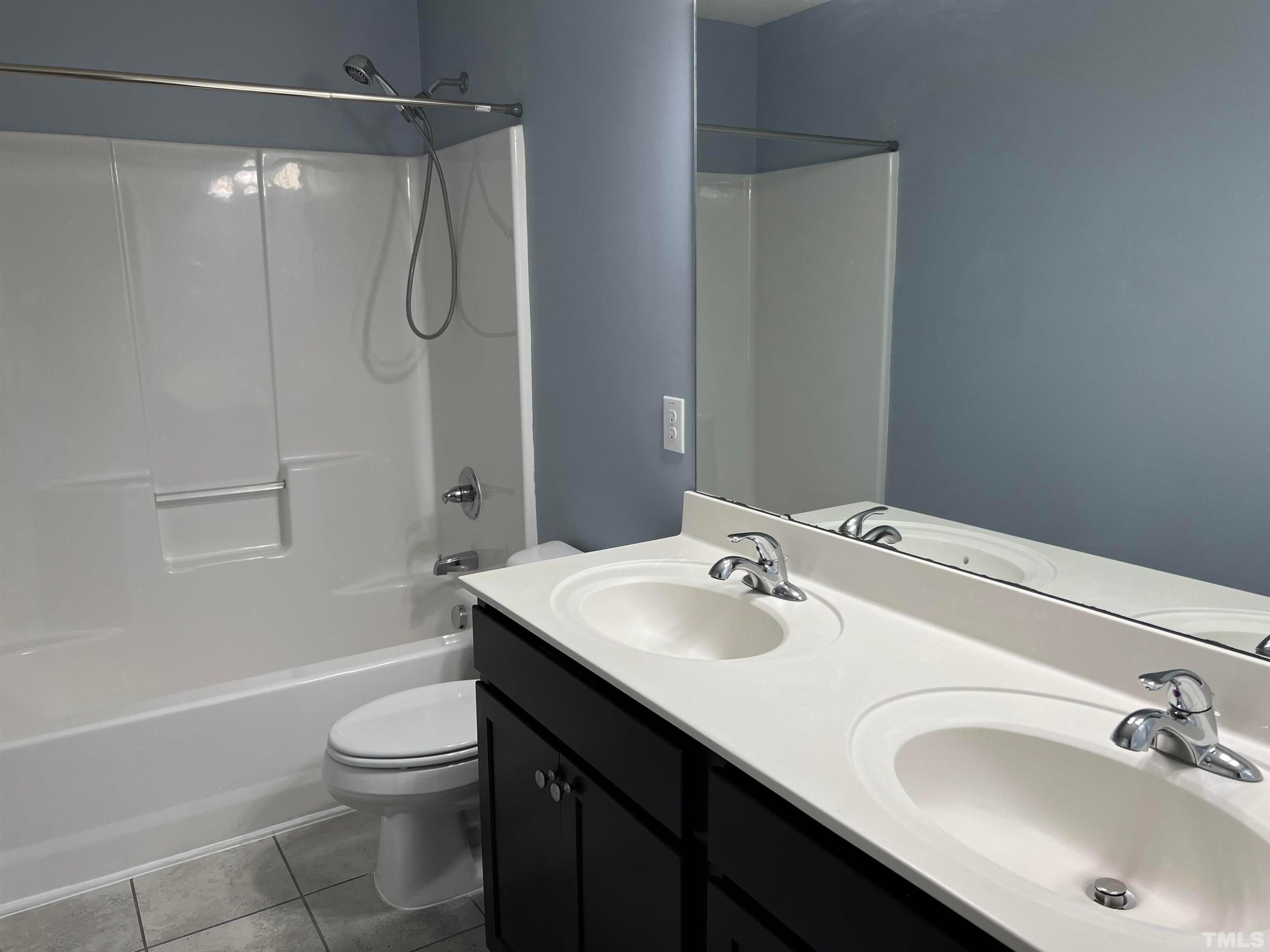 121 Red Bark Court Apex, NC 27539 - Photo 20 of 24 a bathroom with a sink toilet tub and shower