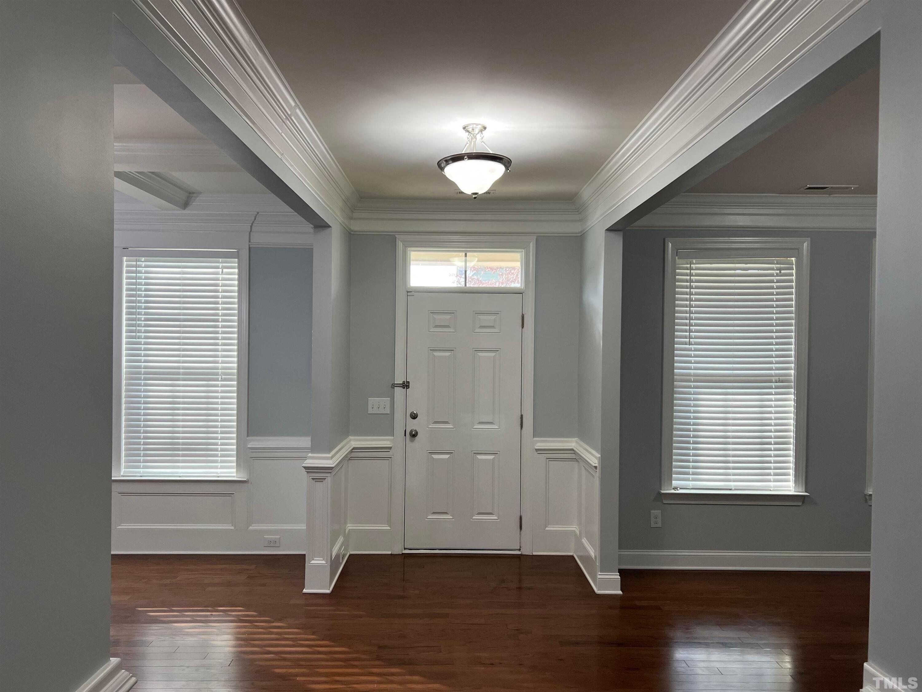 121 Red Bark Court Apex, NC 27539 - Photo 6 of 24 an empty room with wooden floor and windows
