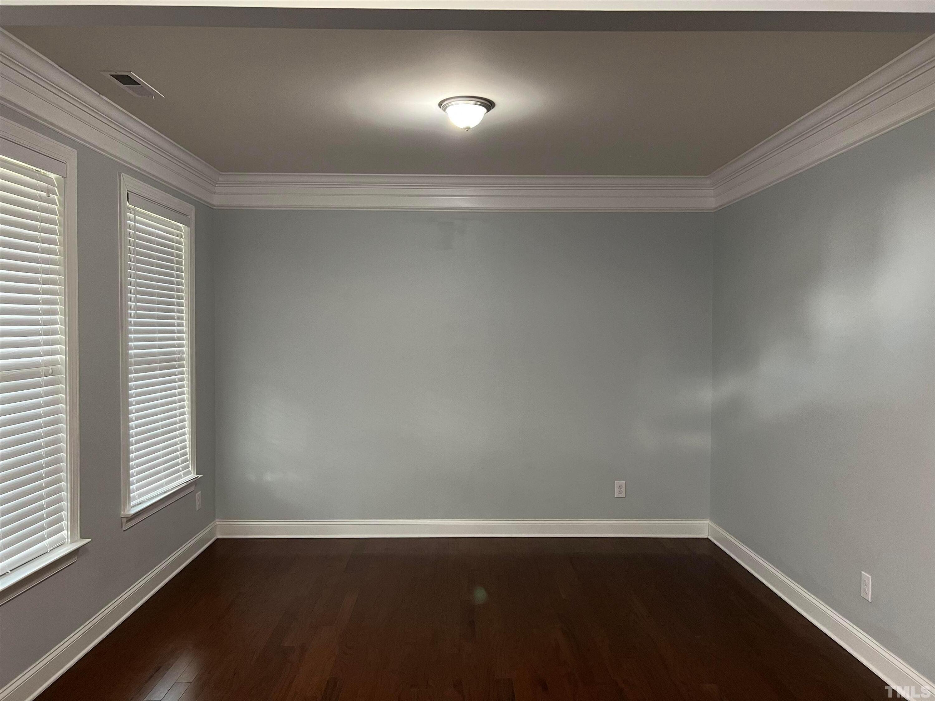 121 Red Bark Court Apex, NC 27539 - Photo 7 of 24 an empty room with wooden floor and windows