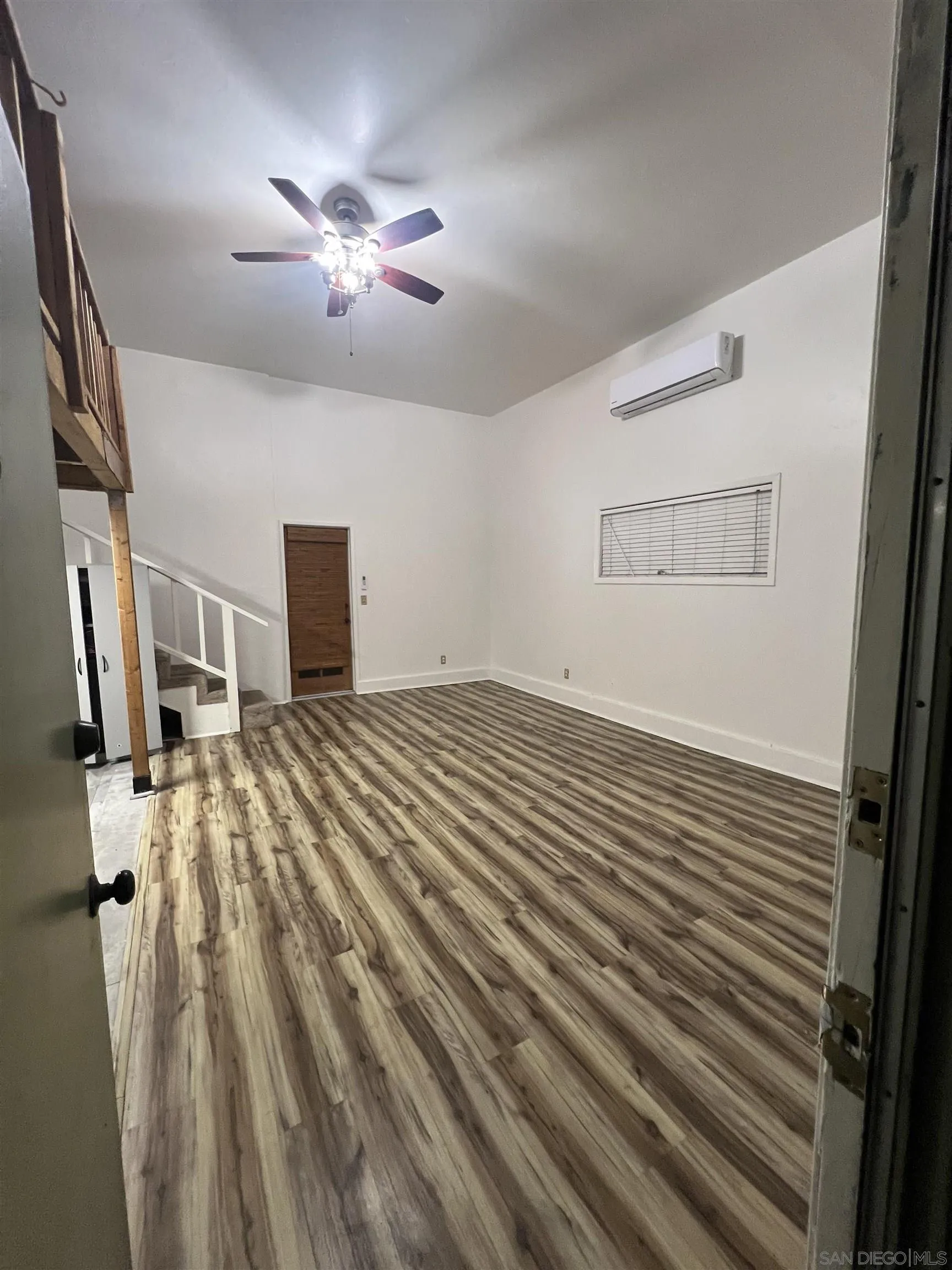 3246 Sweetwater Road Lemon Grove, CA 91945 - Photo 5 of 13 a view of a livingroom with wooden floor and staircase