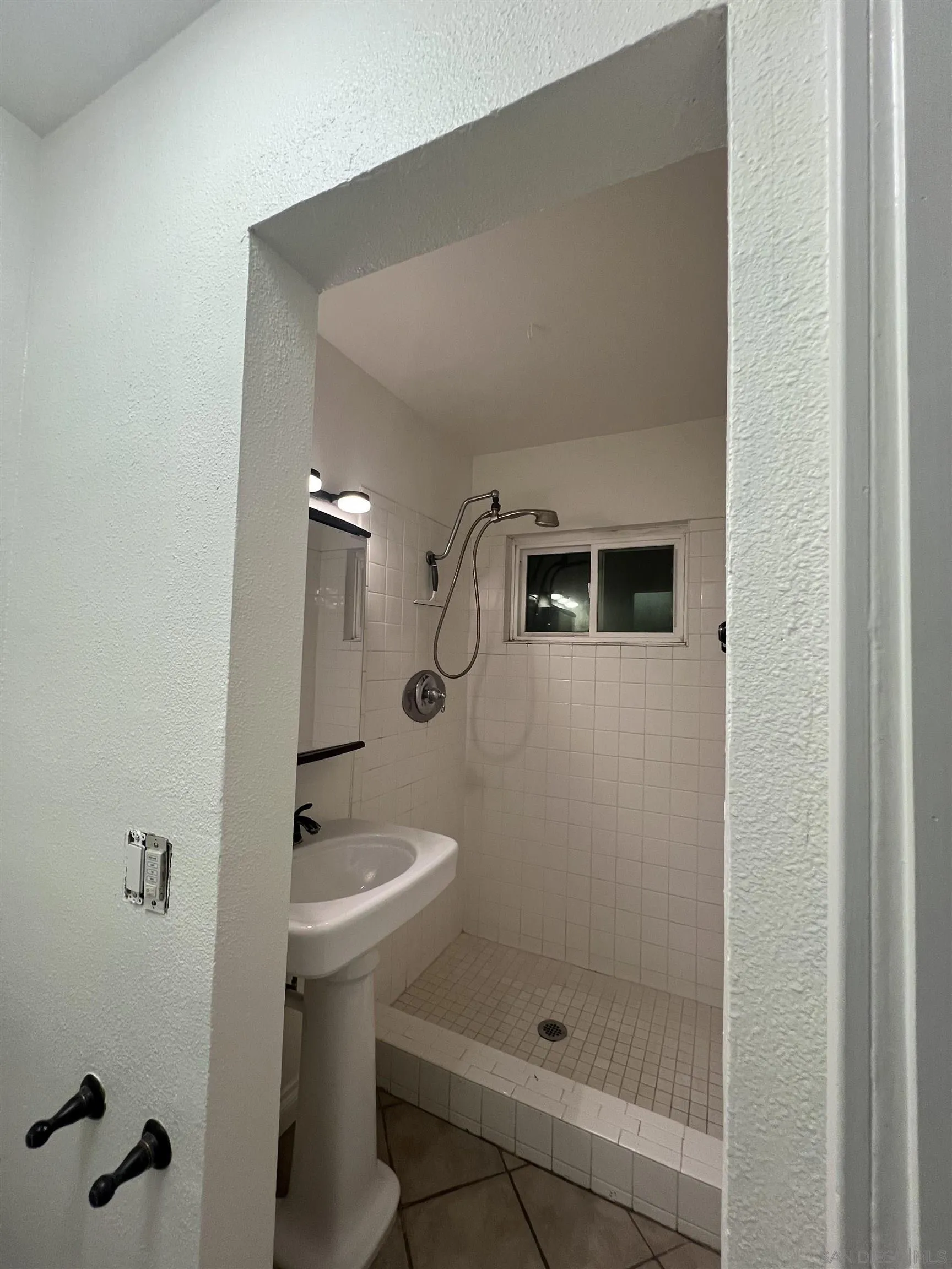 3246 Sweetwater Road Lemon Grove, CA 91945 - Photo 8 of 13 a bathroom with a sink a toilet and shower