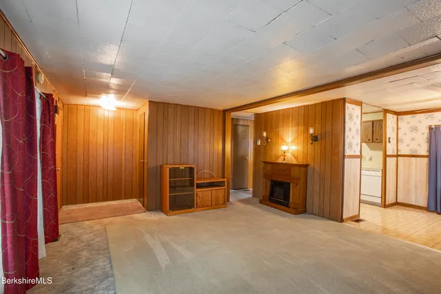 a view of a livingroom with furniture fire place and windows