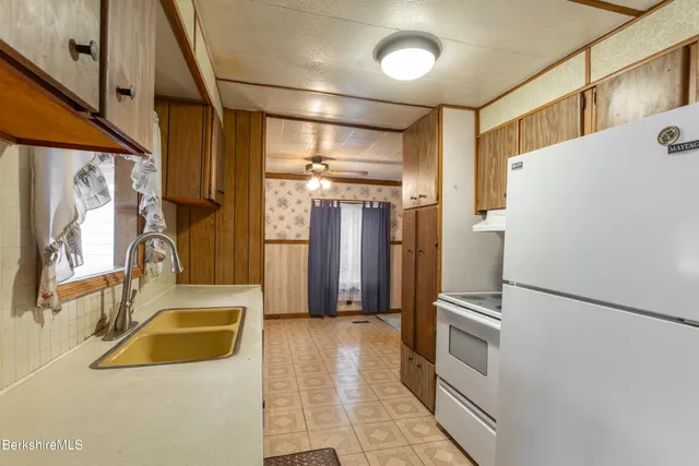 a kitchen with refrigerator and window