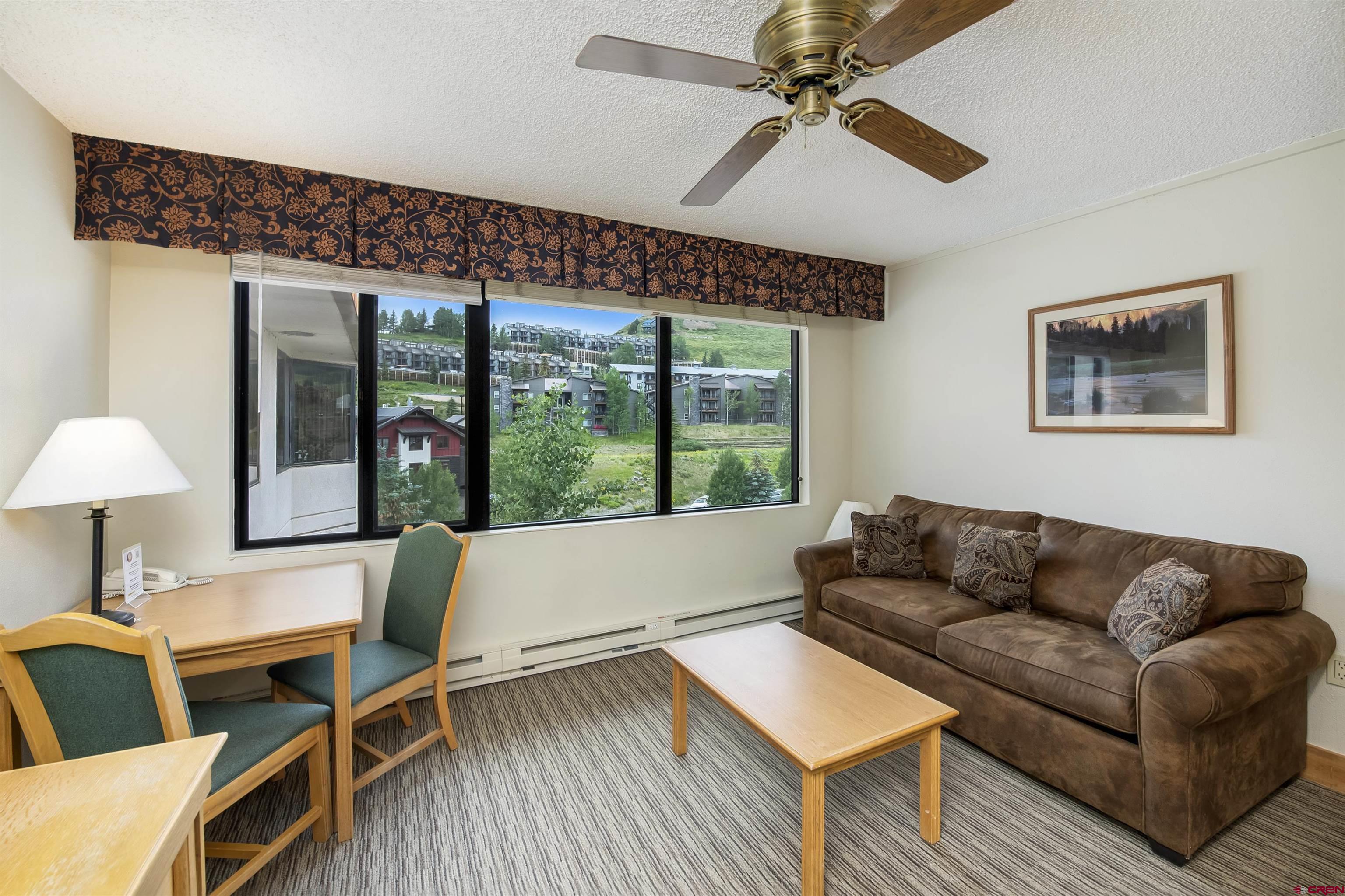 6 Emmons Road, Unit 572 Crested Butte, CO 81225 - Photo 22 of 26 a living room with furniture and a large window