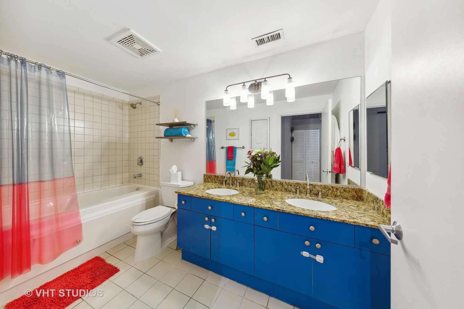 1301 West Madison Street, Unit 314 Chicago, IL 60607 - Photo 13 of 14 a bathroom with a granite countertop sink a toilet and shower