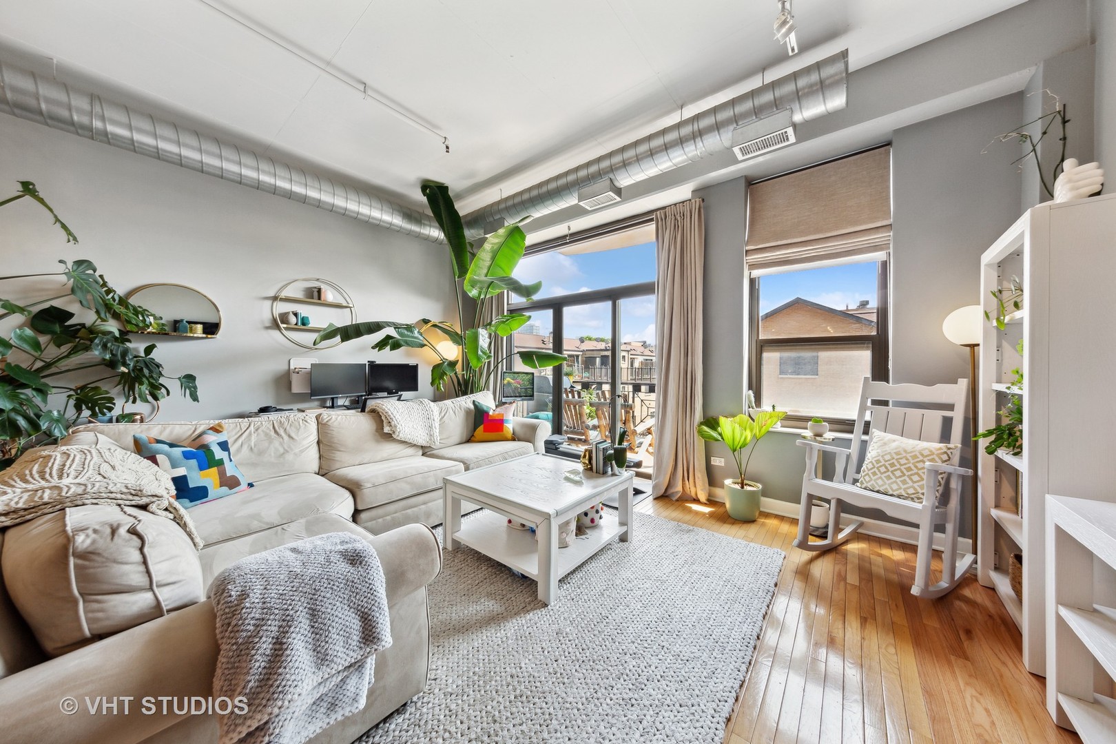 1301 West Madison Street, Unit 314 Chicago, IL 60607 - Photo 3 of 14 a living room with furniture and wooden floor