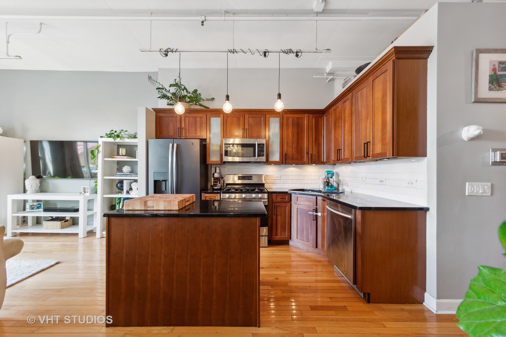 1301 West Madison Street, Unit 314 Chicago, IL 60607 - Photo 7 of 14 a kitchen with stainless steel appliances granite countertop a refrigerator a sink dishwasher a stove and a oven with wooden floor