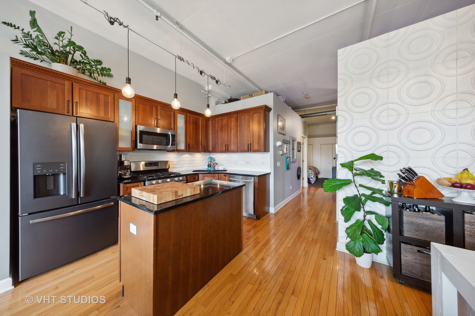 1301 West Madison Street, Unit 314 Chicago, IL 60607 - Photo 8 of 14 a kitchen with stainless steel appliances granite countertop a refrigerator a stove top oven a sink and dishwasher