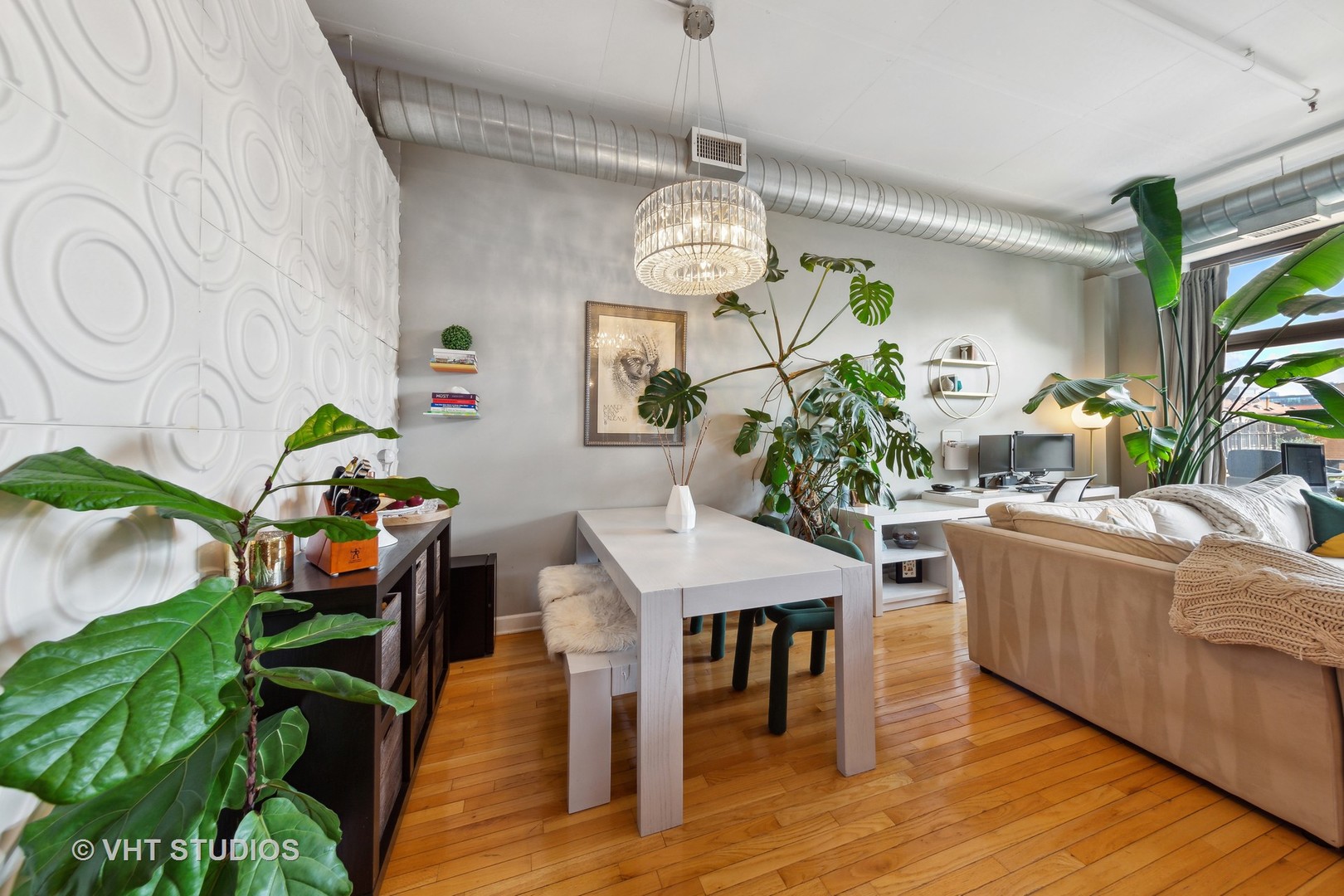 1301 West Madison Street, Unit 314 Chicago, IL 60607 - Photo 9 of 14 a living room with furniture and a chandelier