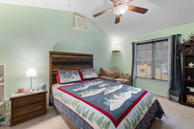 a living room with a bed furniture and a flat screen tv