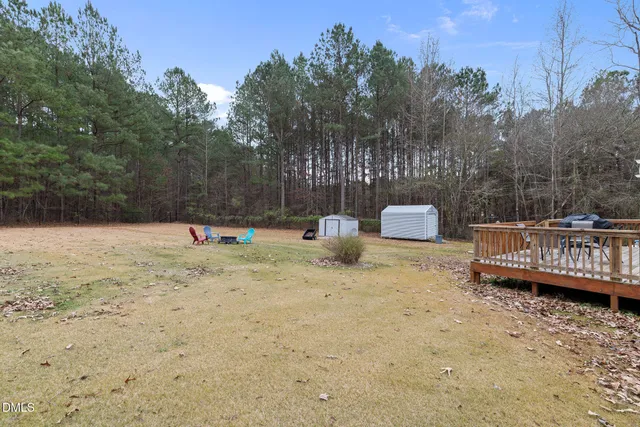 a backyard of a house with hardwood and trees