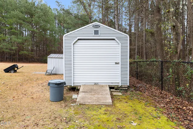 a white house with trees in the background