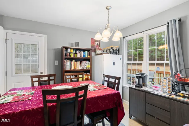 a dining room with furniture and window