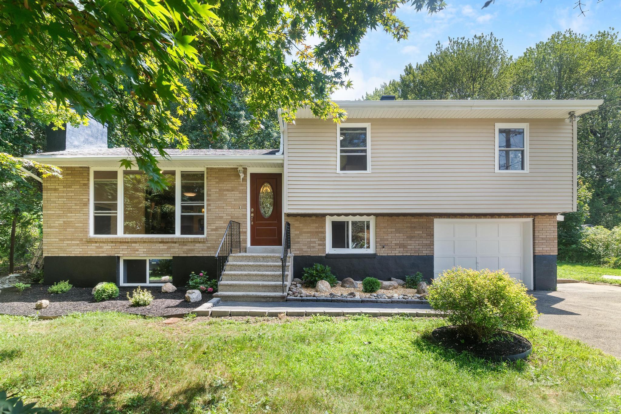 55 Colby Lane Wolcott, CT 06716 - Photo 1 of 1 a front view of house with yard and outdoor seating