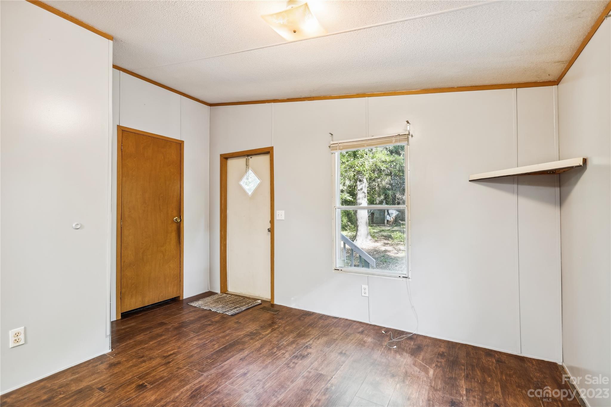 4670 Blade Run Road Edgemoor, SC 29712 - Photo 14 of 26 a view of an empty room with wooden floor and a window