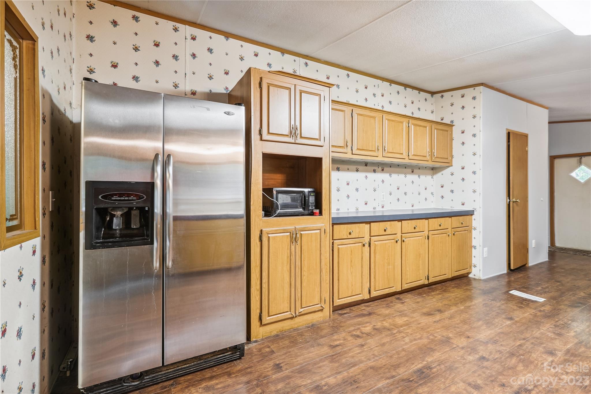 4670 Blade Run Road Edgemoor, SC 29712 - Photo 18 of 26 a view of a refrigerator in kitchen and an empty room