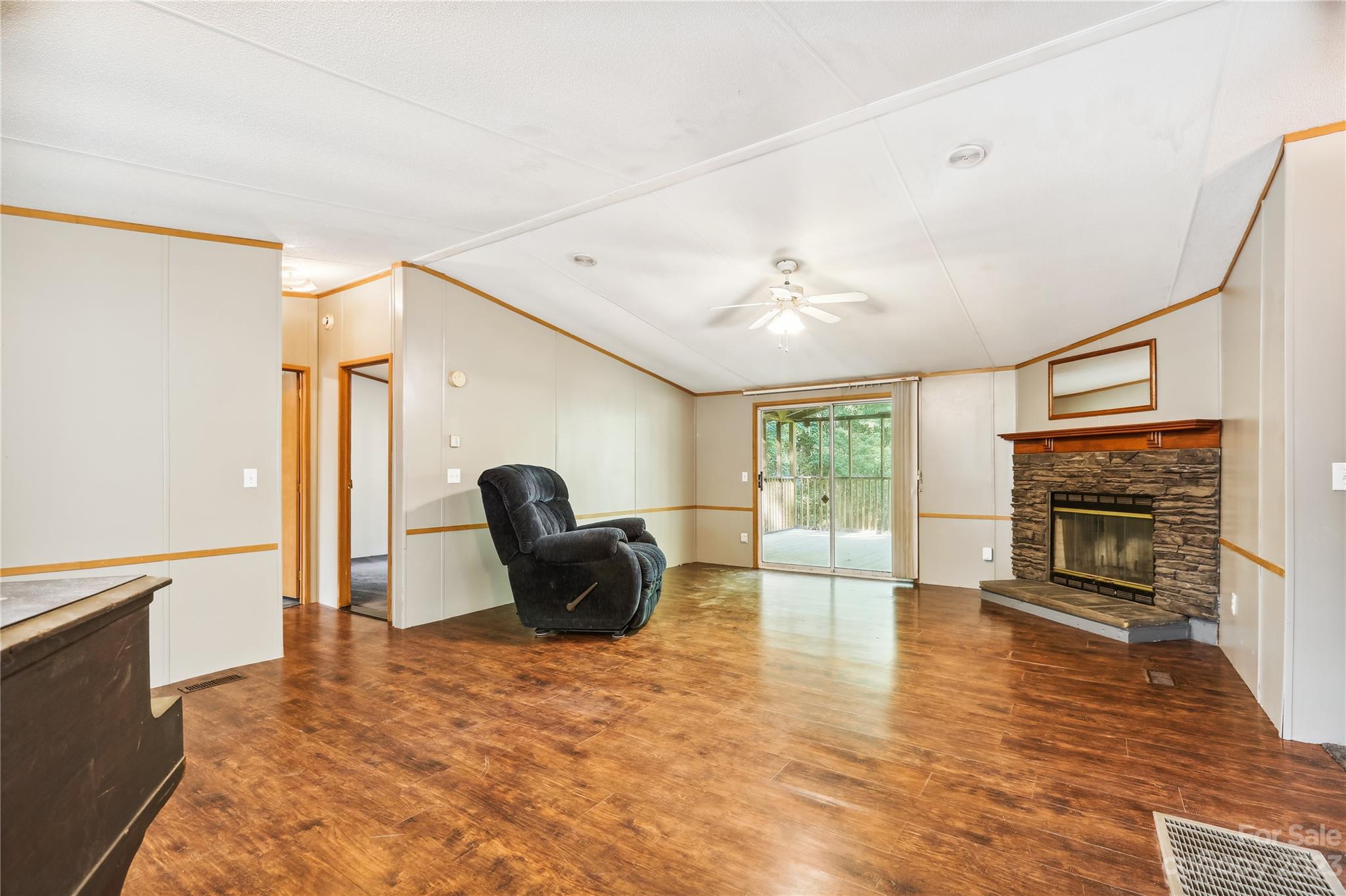 4670 Blade Run Road Edgemoor, SC 29712 - Photo 19 of 26 a living room with furniture a fireplace and a flat screen tv