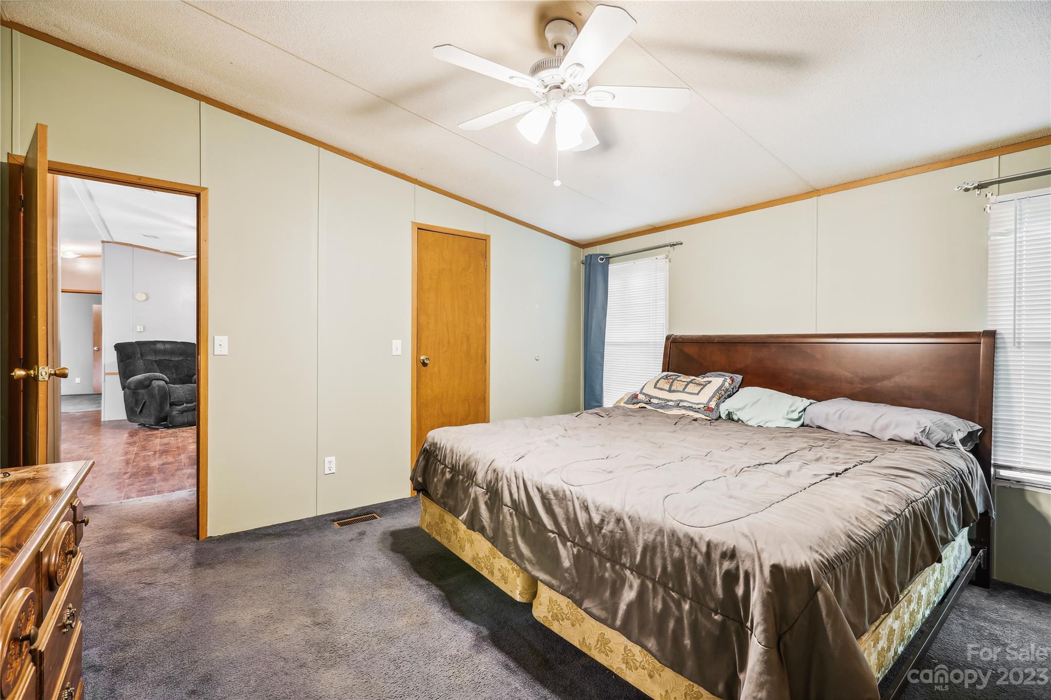 4670 Blade Run Road Edgemoor, SC 29712 - Photo 24 of 26 a bedroom with a bed and a chandelier
