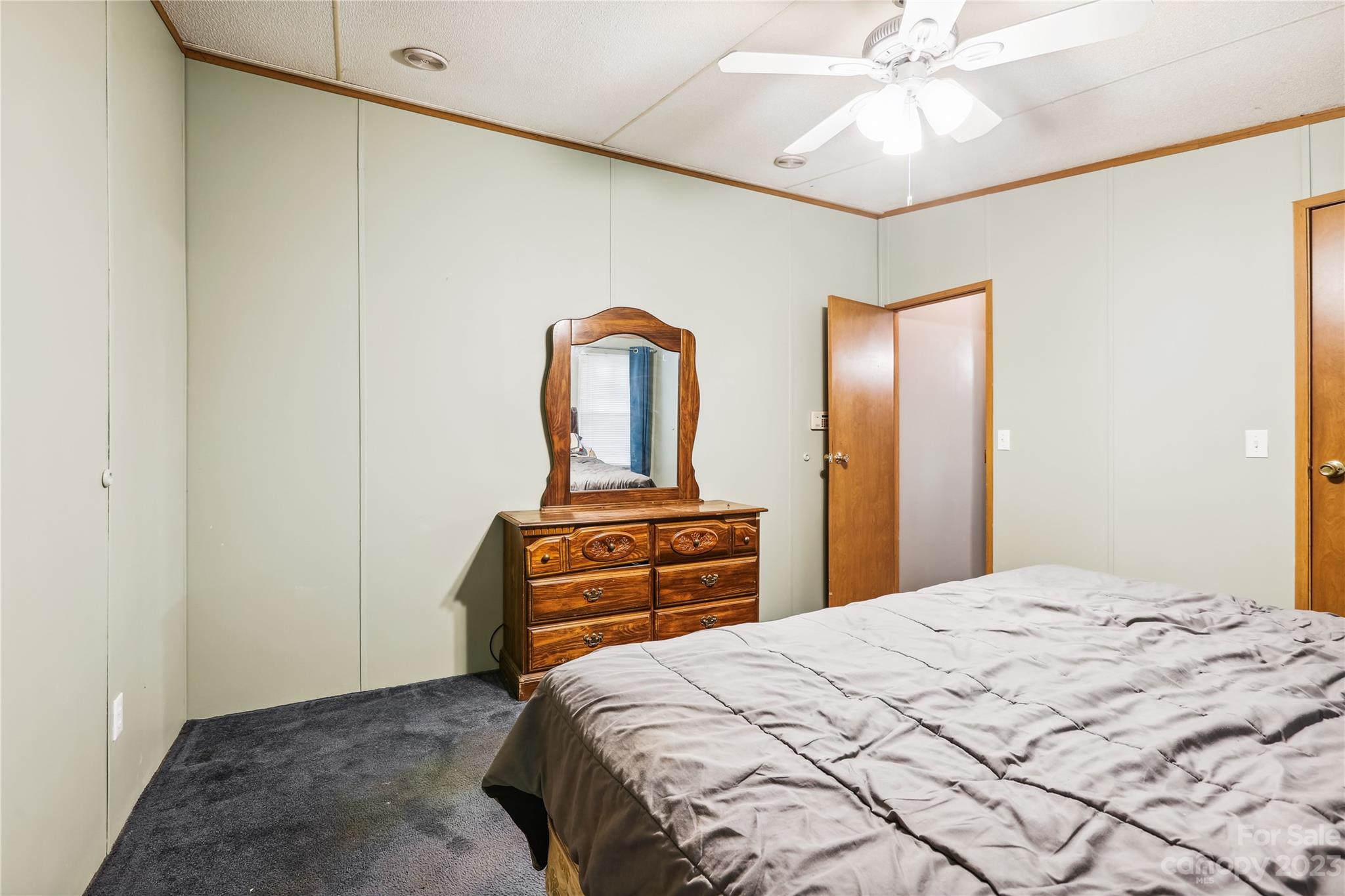 4670 Blade Run Road Edgemoor, SC 29712 - Photo 25 of 26 a bedroom with a bed and a chandelier