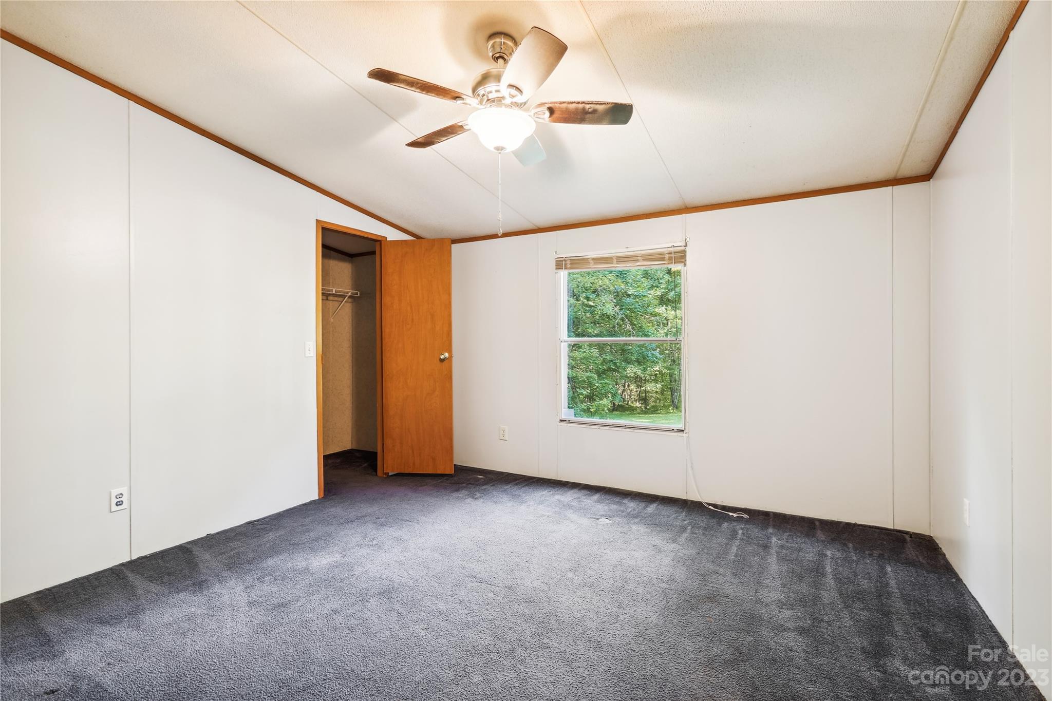 4670 Blade Run Road Edgemoor, SC 29712 - Photo 9 of 26 an empty room with windows and fan