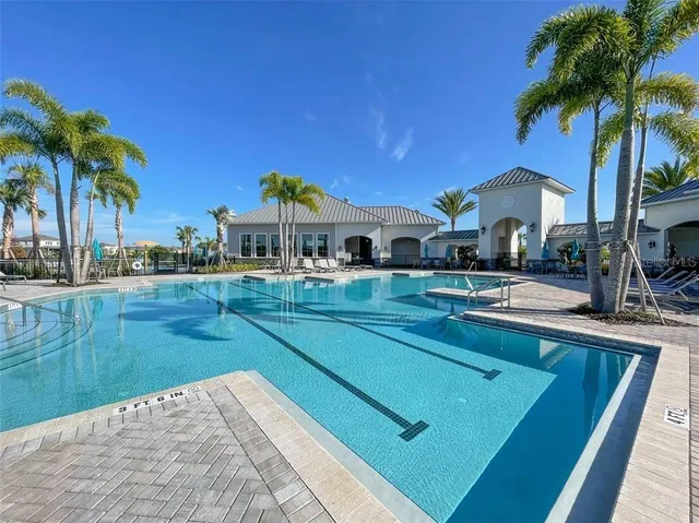 a view of a house with swimming pool and a trees