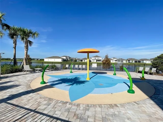 a view of a swimming pool with an outdoor space and seating area
