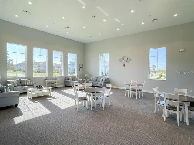 a living room with lots of furniture and a large window